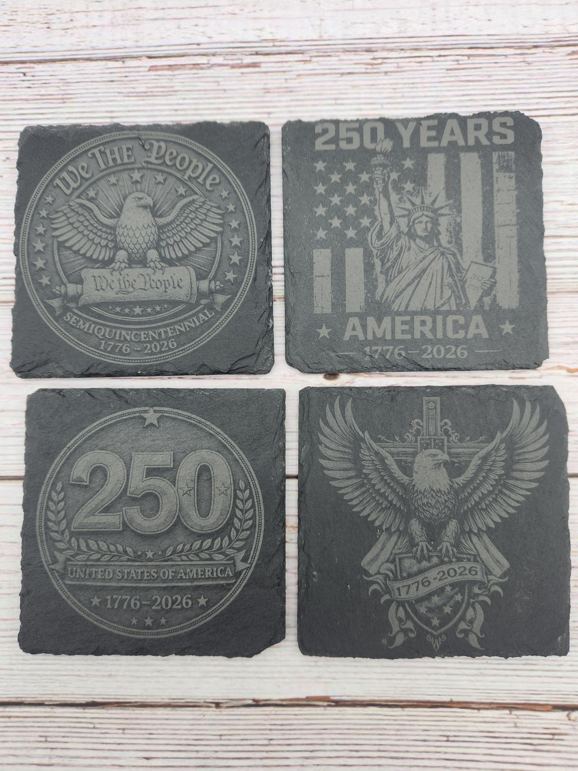 Celebrate America's 250th Anniversary with this engraved slate coaster set featuring four patriotic designs honoring the United States Semiquincentennial (1776–2026). These laser engraved natural slate coasters make perfect America 250 gifts, patriotic home décor, Fourth of July decorations, veteran gifts, military family gifts, and commemorative keepsakes.

Ideal for home bars, offices, man caves, patriotic celebrations, and collectors looking to commemorate this historic milestone.